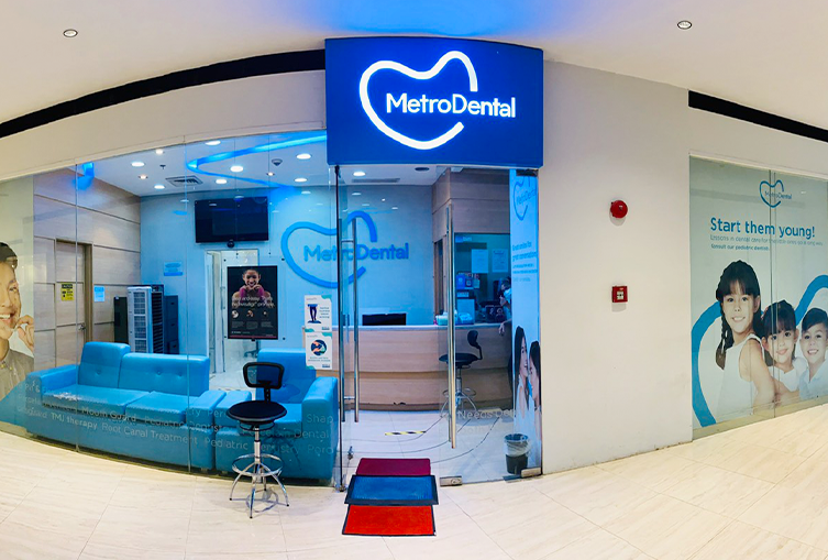 Prominent blue and white sign showcasing "Metro Dental" for a professional dental clinic.