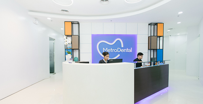 A professional reception area at Metro Dental office, showcasing a well-lit space with contemporary furniture and a welcoming ambiance.