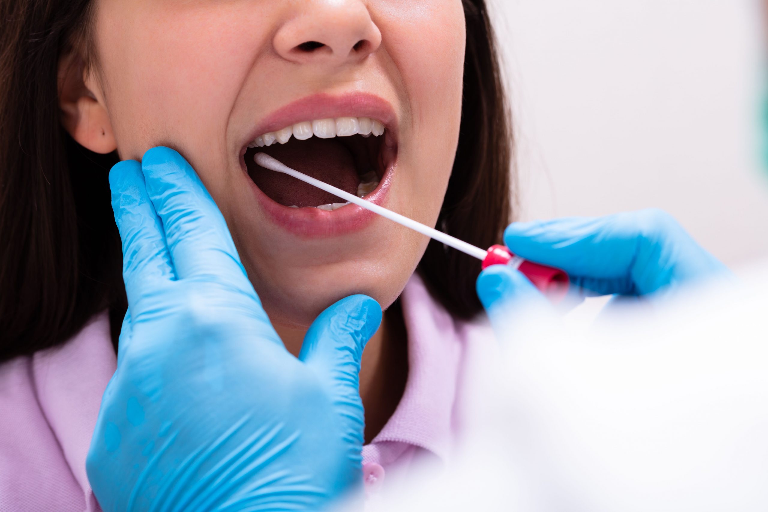 Female patient receiving dental check-up from dentist