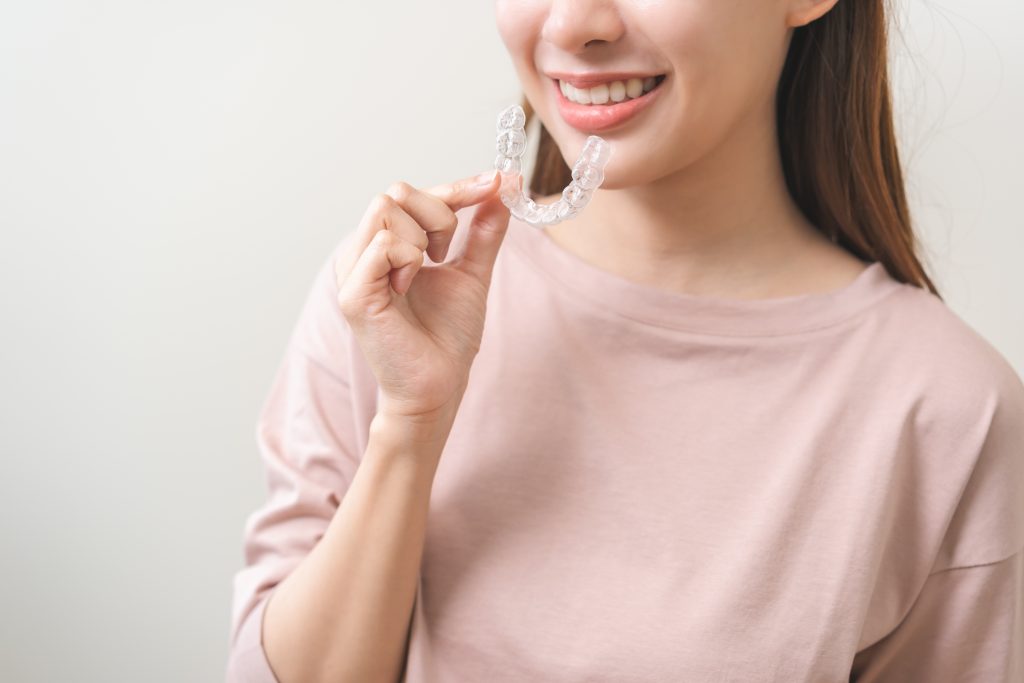 a woman about to wear an invisalign